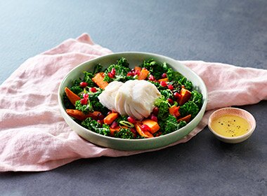 Poached skrei on a bed of sweet potato and kale 