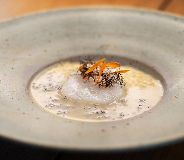Baked Norwegian skrei with sago porridge and a sauce of truffle seaweed